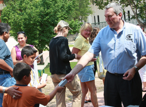 Dave McComas Handing Out IBEX Flashlights to Children that Attended the IBEX Show